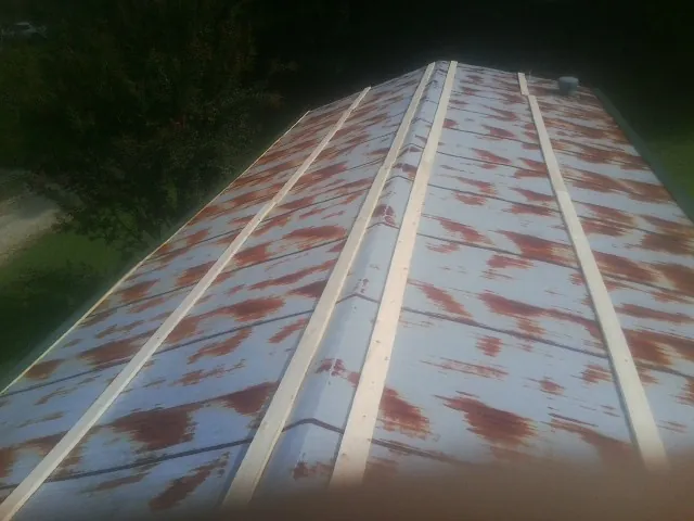 Rusted metal roof panels with new wood purlins before replacement — Storm Damage Roof Repair in Murrayville by Roofing Brothers