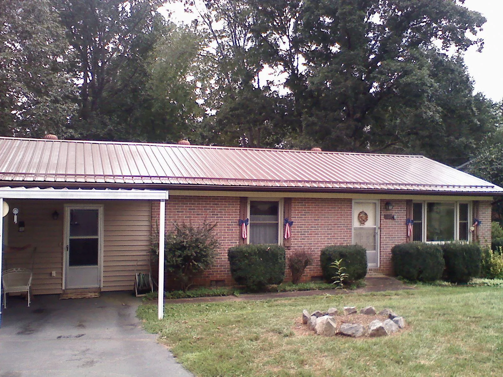 Bronze metal roof and carport on a brick ranch home — Roof Repair work by our crew in Murrayville