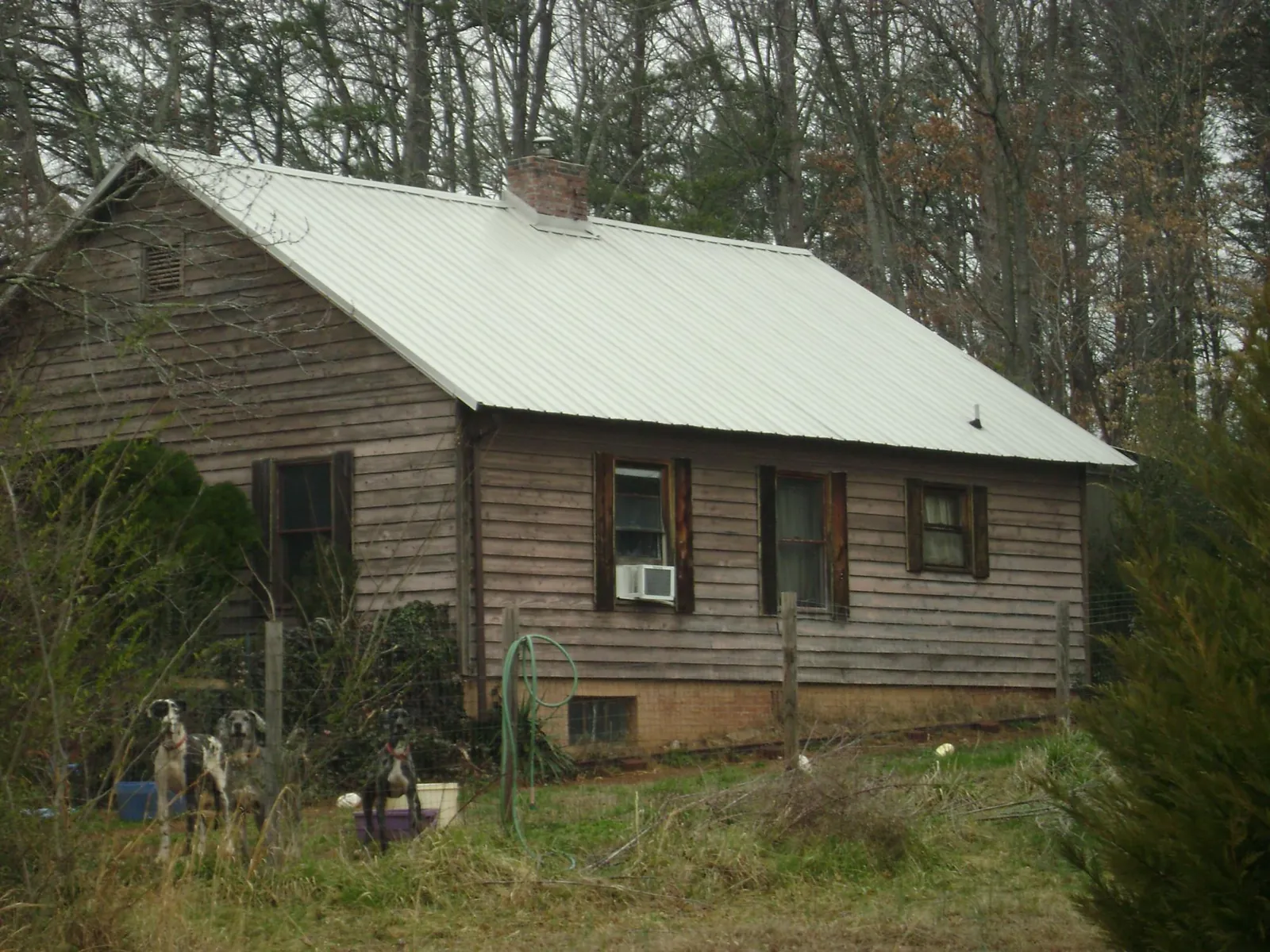 White metal roof on an old wood sided farmhouse, from a Metal Roof Installation job in Murrayville